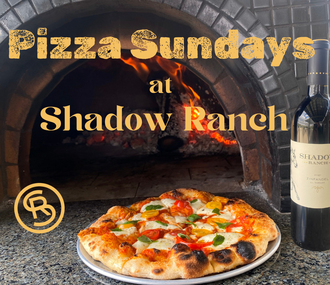 Image of margherita pizza and bottle of wine in front of wood-fired pizza oven. Text reads Pizza Sundays at Shadow Ranch