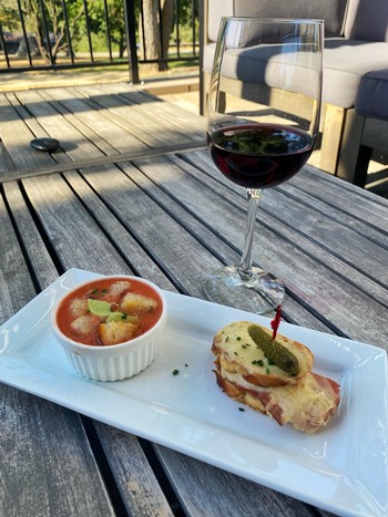 glass of wine paired with food, outdoors